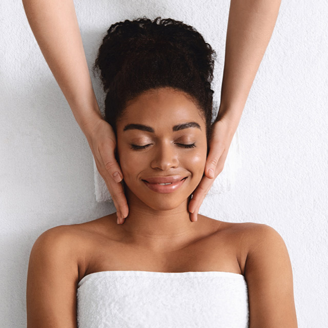 A woman receiving a cleansing facial