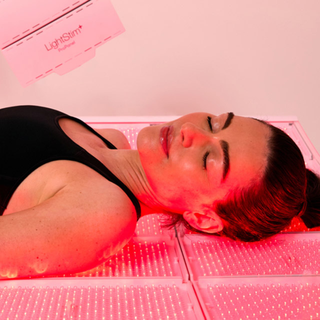 A woman enjoying a Red Light Therapy by LightStim full-body session