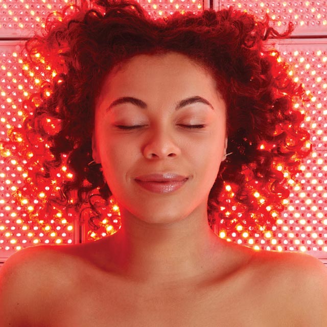 A woman enjoying a full-body Red Light by LightStim session