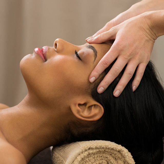 A woman receiving a cleansing facial
